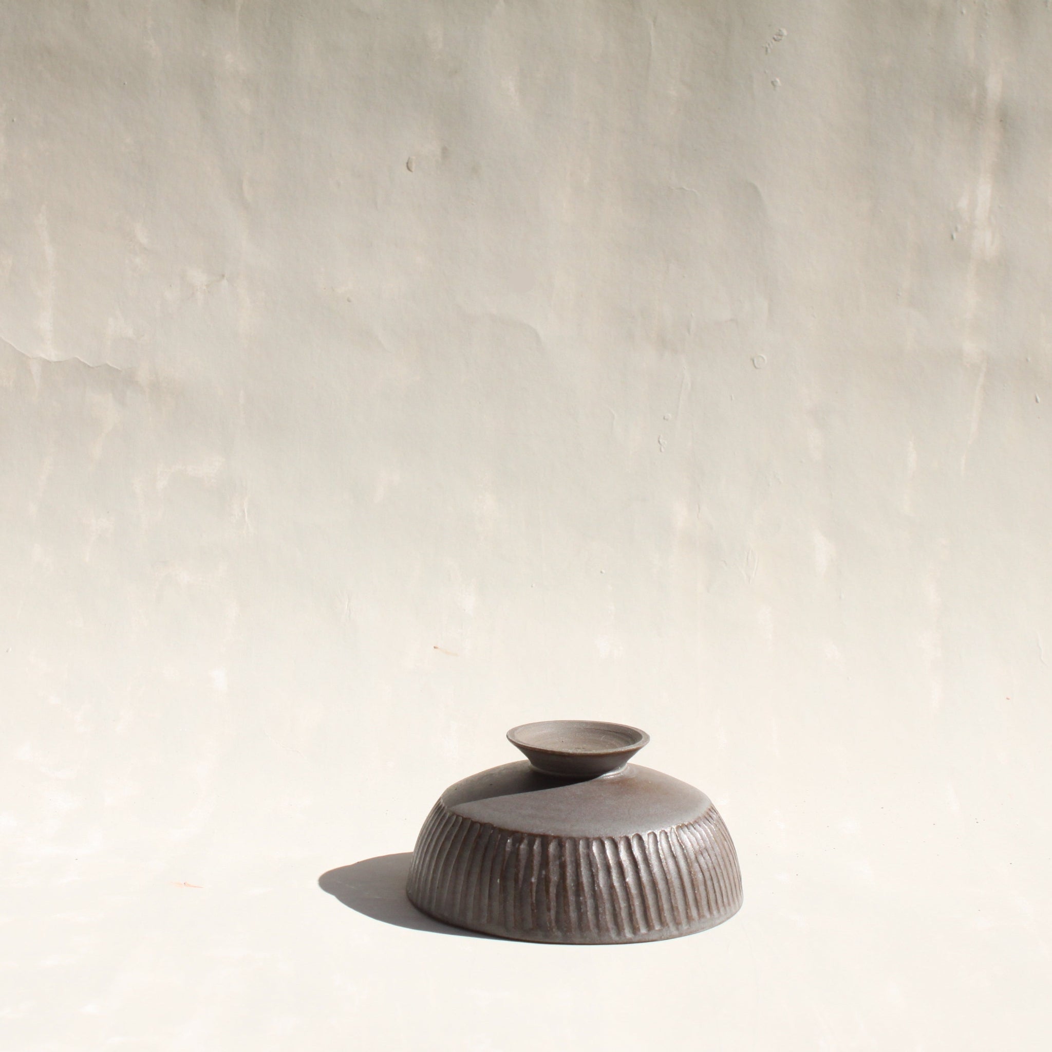 Das abnehmbare Schälchen der Karaffe AIRONE aus Keramik, das Schölchen dienst auch als Fuss der Karaffe.